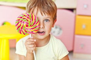 Happy kid with a big candy