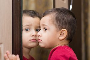 boy 2 years in front of the mirror